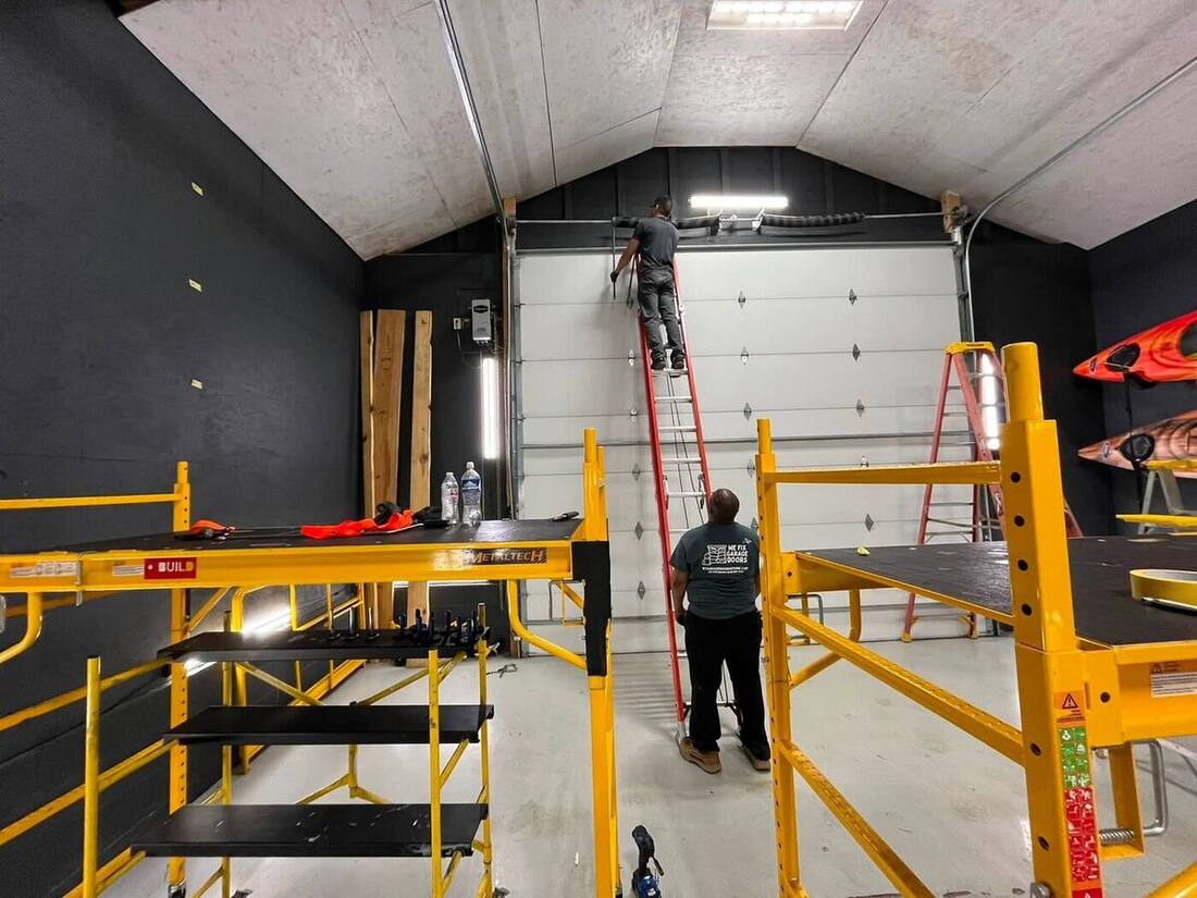 We Fix Garage Doors crew installing a tall commercial door